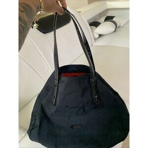Agnès b. Voyage small black nylon bag with strap details.